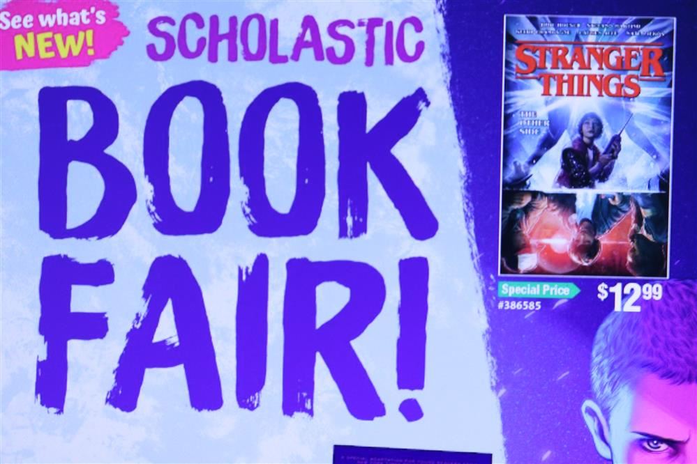  Purple flyer with the words Scholastic Book Fair